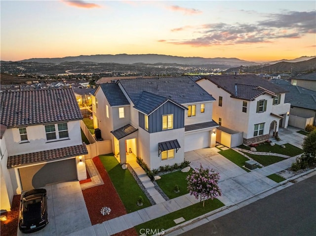 28537 Daybreak Way, Saugus, CA 91350 - view of front facade with an attached garage, concrete driveway, a mountain view, and stucco siding