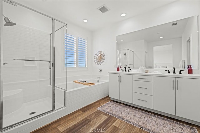 28537 Daybreak Way, Saugus, CA 91350 - full bath featuring a shower stall, double vanity, a garden tub, wood finished floors, and recessed lighting