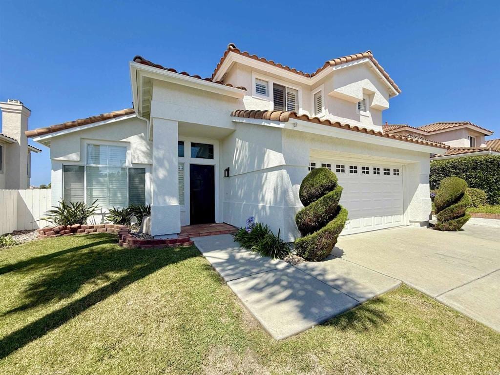 653 Montage Rd, Oceanside, CA 92057 - mediterranean / spanish-style house with driveway, stucco siding, and a tile roof