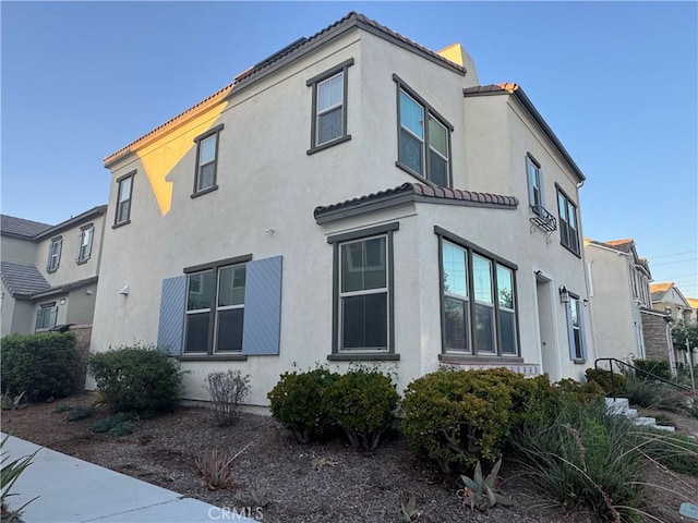 3249 E Butterfly Ln, Ontario, CA 91762 - view of property exterior with stucco siding and a tile roof