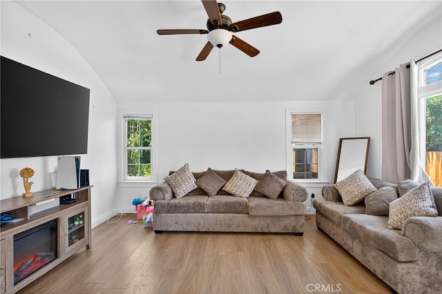 8627 John Ave, Los Angeles, CA 90002 - living room with lofted ceiling, plenty of natural light, wood finished floors, and ceiling fan