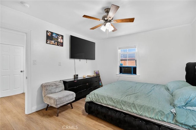 8627 John Ave, Los Angeles, CA 90002 - bedroom featuring light wood finished floors, ornamental molding, and a ceiling fan