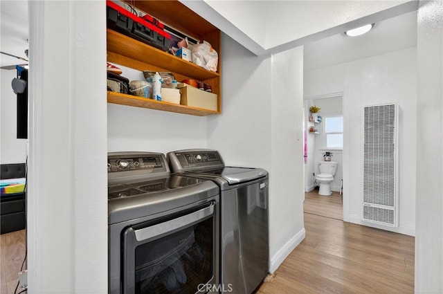 8627 John Ave, Los Angeles, CA 90002 - washroom with a heating unit, independent washer and dryer, and wood finished floors