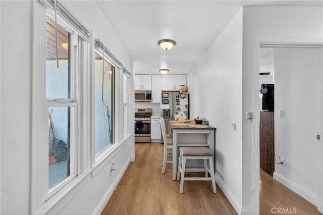 8627 John Ave, Los Angeles, CA 90002 - corridor featuring light wood-style floors and healthy amount of natural light