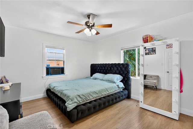 8627 John Ave, Los Angeles, CA 90002 - bedroom featuring multiple windows, wood finished floors, cooling unit, and crown molding