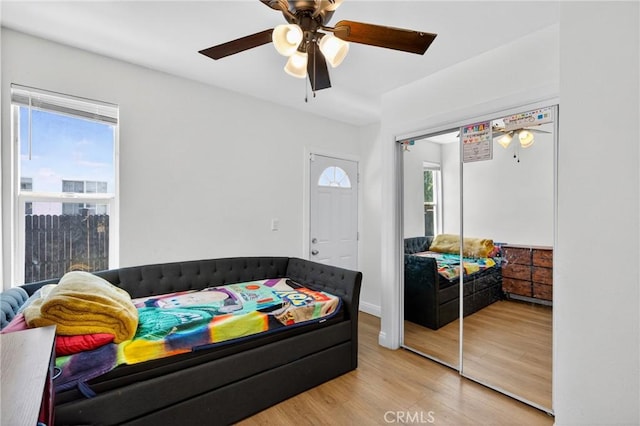 8627 John Ave, Los Angeles, CA 90002 - bedroom with multiple windows, a closet, wood finished floors, and ceiling fan