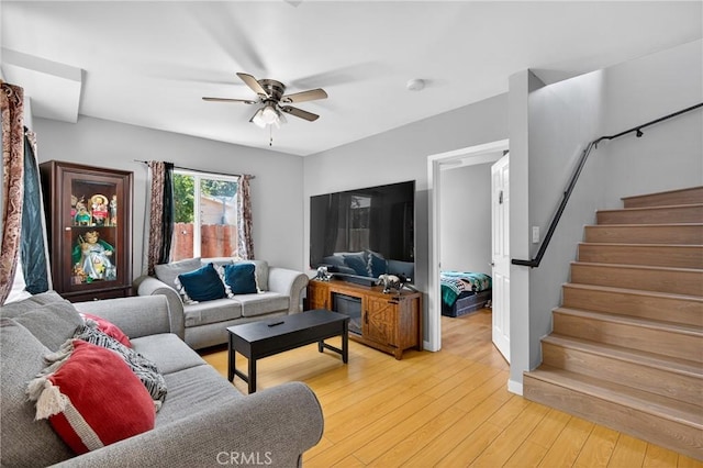 8627 John Ave, Los Angeles, CA 90002 - living area featuring a ceiling fan, stairs, and light wood-style floors