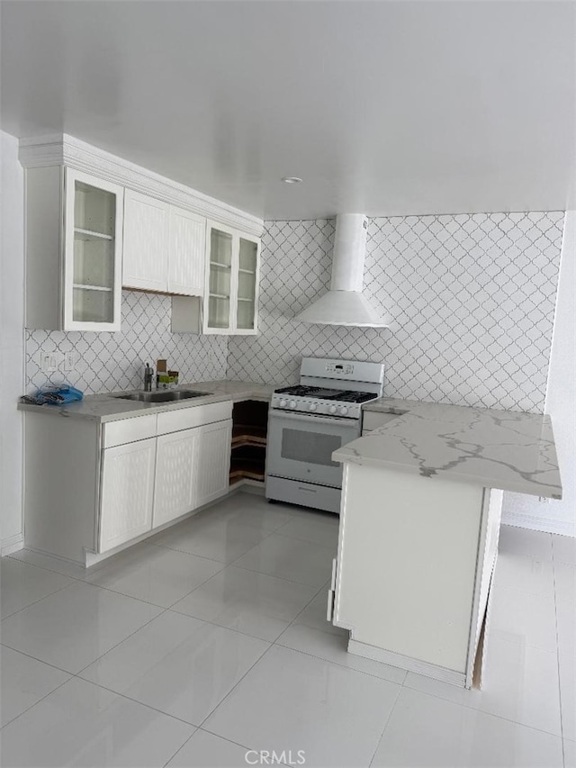 14730 S Normandie Ave Unit 3, Gardena, CA 90247 - kitchen featuring white gas range, wall chimney range hood, light tile patterned floors, backsplash, and white cabinetry