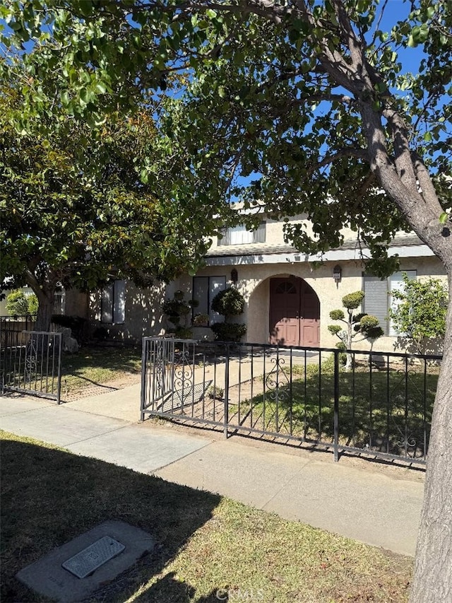 14730 S Normandie Ave Unit 3, Gardena, CA 90247 - obstructed view of property with stucco siding, a fenced front yard, and a gate
