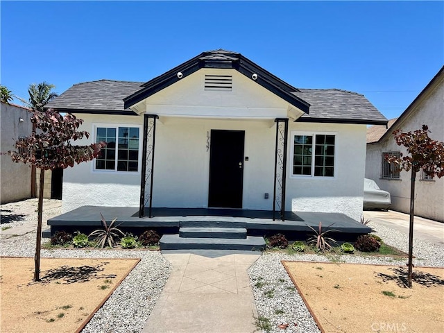 1737 W 65th Pl, Los Angeles, CA 90047 - view of front of home with stucco siding, a porch, and roof with shingles