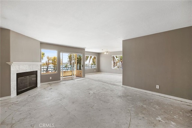 2222 S Mesa St Unit 8, San Pedro, CA 90731 - unfurnished living room featuring a tiled fireplace, a chandelier, and a textured ceiling