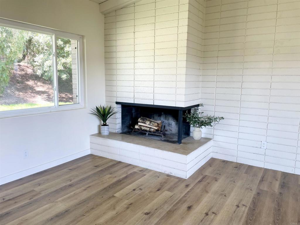 7855 Montana St, Lemon Grove, CA 91945 - detailed view of wood finished floors and a multi sided fireplace