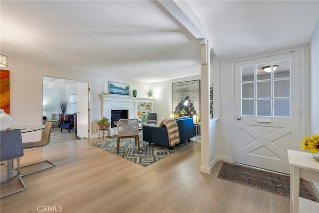 14453 Watkins Dr, La Mirada, CA 90638 - living room with wood finished floors and a brick fireplace