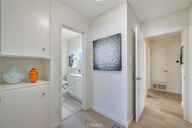 14453 Watkins Dr, La Mirada, CA 90638 - hallway with light wood-style floors and baseboards
