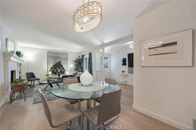 14453 Watkins Dr, La Mirada, CA 90638 - dining room featuring light wood-style flooring and a fireplace