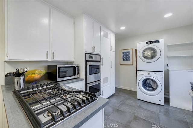 14453 Watkins Dr, La Mirada, CA 90638 - kitchen with appliances with stainless steel finishes, stacked washer and clothes dryer, white cabinets, and recessed lighting