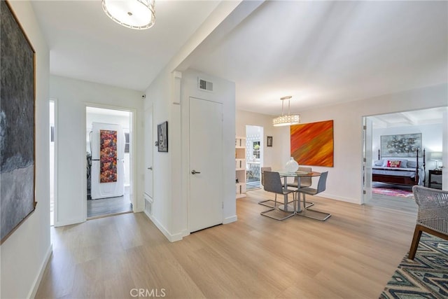 14453 Watkins Dr, La Mirada, CA 90638 - foyer entrance with light wood-style floors and a chandelier