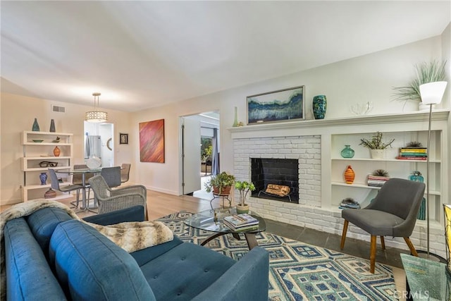 14453 Watkins Dr, La Mirada, CA 90638 - living area with a brick fireplace and wood finished floors
