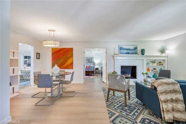 14453 Watkins Dr, La Mirada, CA 90638 - living area with light wood-style floors and a brick fireplace