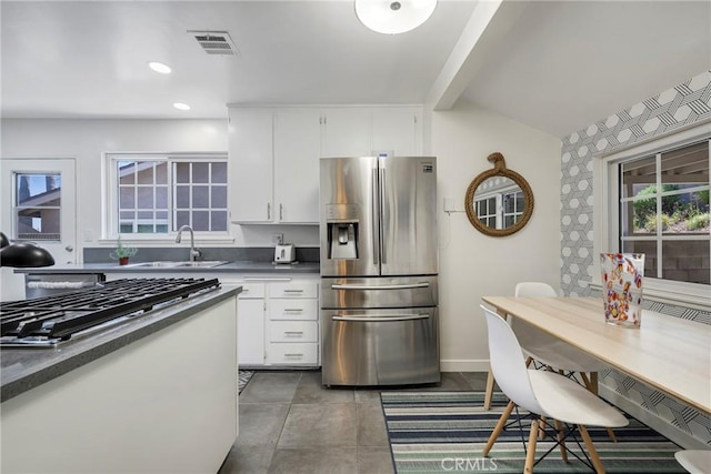 14453 Watkins Dr, La Mirada, CA 90638 - kitchen featuring stainless steel appliances, white cabinetry, dark countertops, recessed lighting, and beamed ceiling