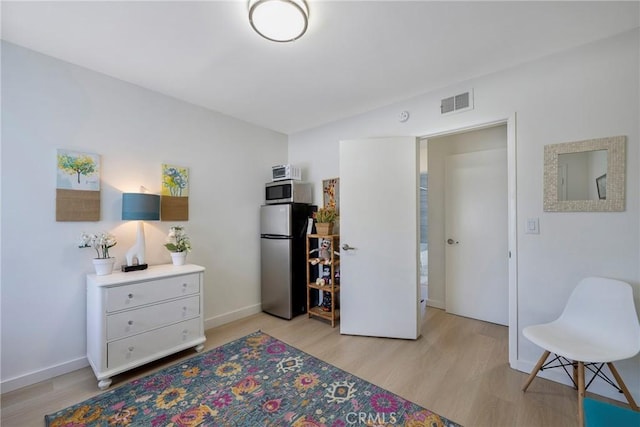 14453 Watkins Dr, La Mirada, CA 90638 - bedroom featuring freestanding refrigerator and light wood-style flooring