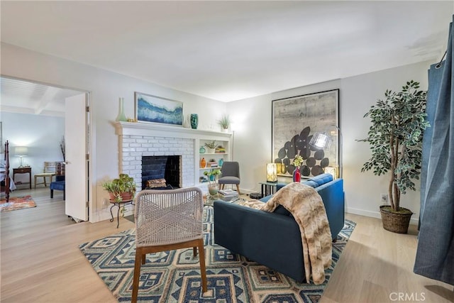 14453 Watkins Dr, La Mirada, CA 90638 - living room featuring light wood-type flooring, a fireplace, and beamed ceiling