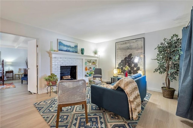 14453 Watkins Dr, La Mirada, CA 90638 - living area with light wood finished floors, a fireplace, and beamed ceiling