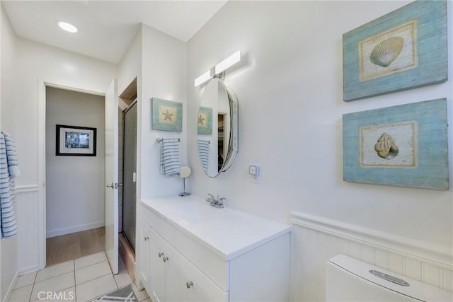 14453 Watkins Dr, La Mirada, CA 90638 - bathroom featuring vanity, a shower stall, tile patterned flooring, and wainscoting