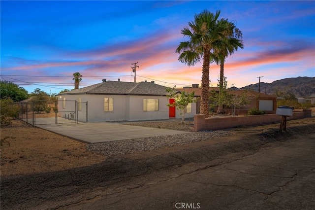 5619 Daisy Ave Unit 29, Palms, CA 92277 - single story home featuring a gate, stucco siding, and a mountain view
