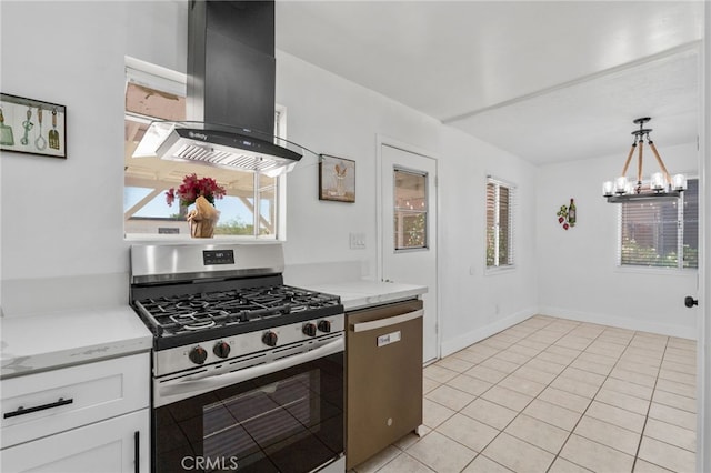 5619 Daisy Ave Unit 29, Palms, CA 92277 - kitchen with appliances with stainless steel finishes, exhaust hood, white cabinets, a chandelier, and light tile patterned floors