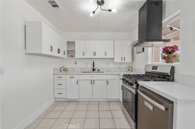 5619 Daisy Ave Unit 29, Palms, CA 92277 - kitchen featuring island range hood, appliances with stainless steel finishes, white cabinetry, open shelves, and light tile patterned flooring