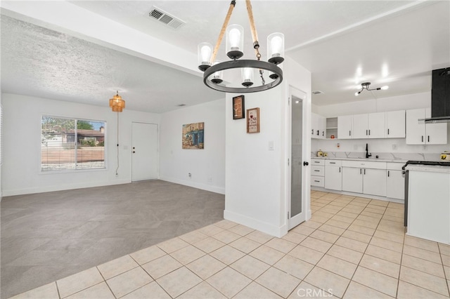 5619 Daisy Ave Unit 29, Palms, CA 92277 - kitchen featuring a chandelier, light tile patterned floors, and wall chimney exhaust hood