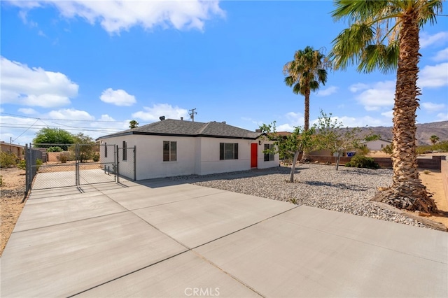 5619 Daisy Ave Unit 29, Palms, CA 92277 - single story home with a gate, driveway, and stucco siding