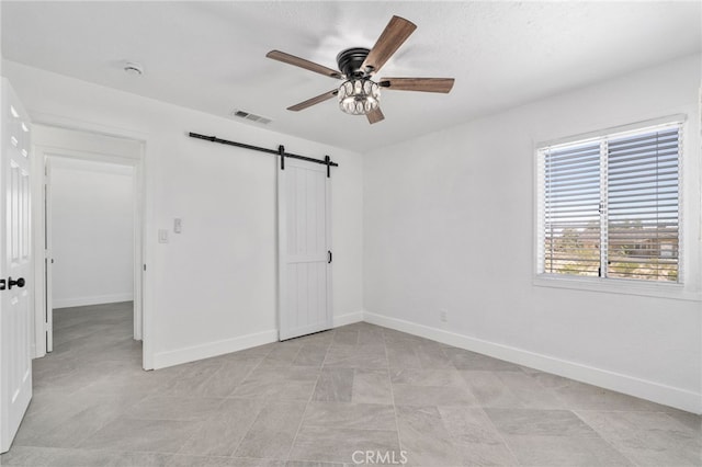 5619 Daisy Ave Unit 29, Palms, CA 92277 - unfurnished bedroom with a barn door and a ceiling fan