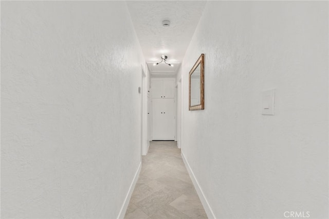 5619 Daisy Ave Unit 29, Palms, CA 92277 - hall featuring baseboards and attic access