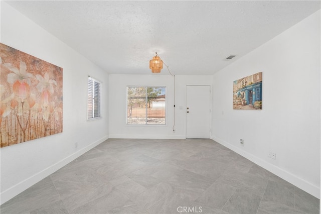 5619 Daisy Ave Unit 29, Palms, CA 92277 - unfurnished room featuring baseboards and a textured ceiling