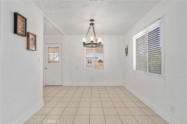5619 Daisy Ave Unit 29, Palms, CA 92277 - unfurnished dining area featuring a chandelier and light tile patterned floors