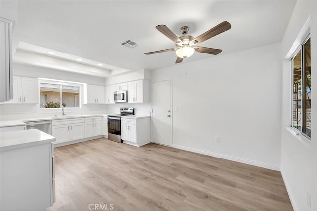 1755 Matthew Ln, Hemet, CA 92545 - kitchen featuring stainless steel appliances, recessed lighting, light wood-style floors, and white cabinetry