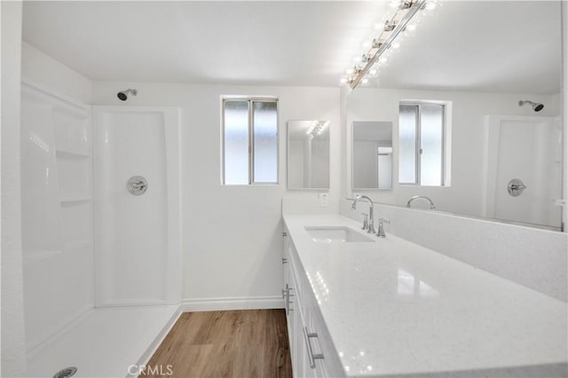 1755 Matthew Ln, Hemet, CA 92545 - bathroom with a shower, healthy amount of natural light, vanity, and wood finished floors