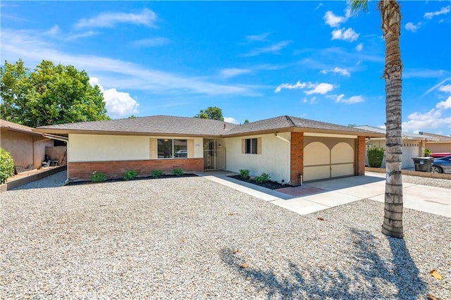 1755 Matthew Ln, Hemet, CA 92545 - single story home with concrete driveway, a garage, brick siding, and stucco siding
