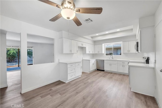 1755 Matthew Ln, Hemet, CA 92545 - kitchen with stainless steel appliances, light wood-type flooring, white cabinetry, a raised ceiling, and ceiling fan