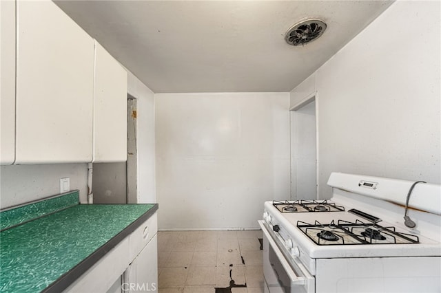 9804 Palmetto Ave, Fontana, CA 92335 - kitchen featuring white gas range oven, white cabinetry, and light flooring
