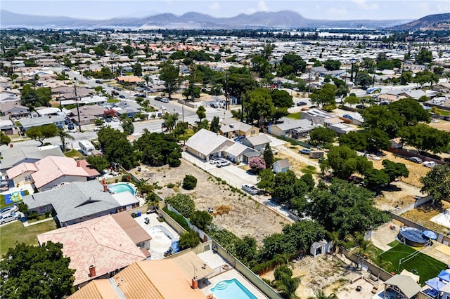 9804 Palmetto Ave, Fontana, CA 92335 - aerial view of residential area with a mountainous background and a pool area