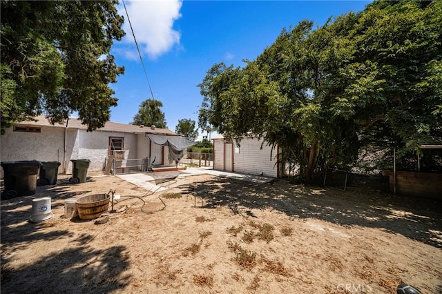 9804 Palmetto Ave, Fontana, CA 92335 - view of yard featuring an outdoor fire pit and a patio