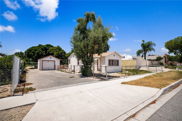 9804 Palmetto Ave, Fontana, CA 92335 - view of front of property with driveway, a fenced front yard, an outdoor structure, and a detached garage