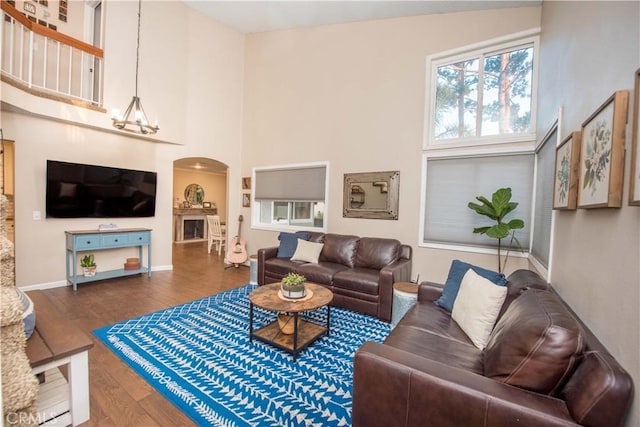 11025 Kenyon Way, Rancho Cucamonga, CA 91701 - living area featuring arched walkways, wood finished floors, and a high ceiling