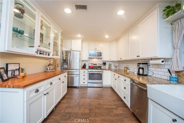 11025 Kenyon Way, Rancho Cucamonga, CA 91701 - kitchen with appliances with stainless steel finishes, butcher block counters, dark wood-type flooring, white cabinets, and recessed lighting