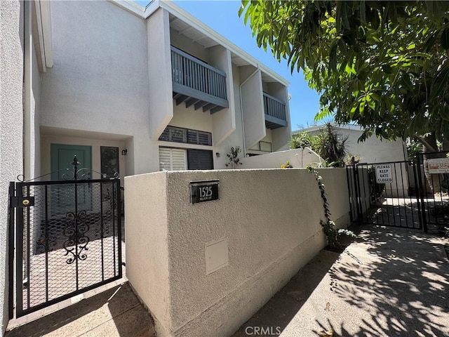 1525 Welldow Ln, Fullerton, CA 92831 - view of side of property with a gate and stucco siding
