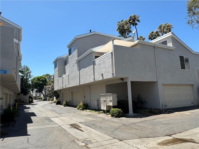 1525 Welldow Ln, Fullerton, CA 92831 - view of home's exterior featuring a garage, stucco siding, and driveway