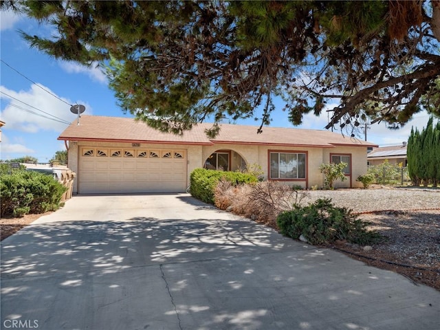 14719 Juniper St, Hesperia, CA 92345 - ranch-style home featuring an attached garage, driveway, and stucco siding